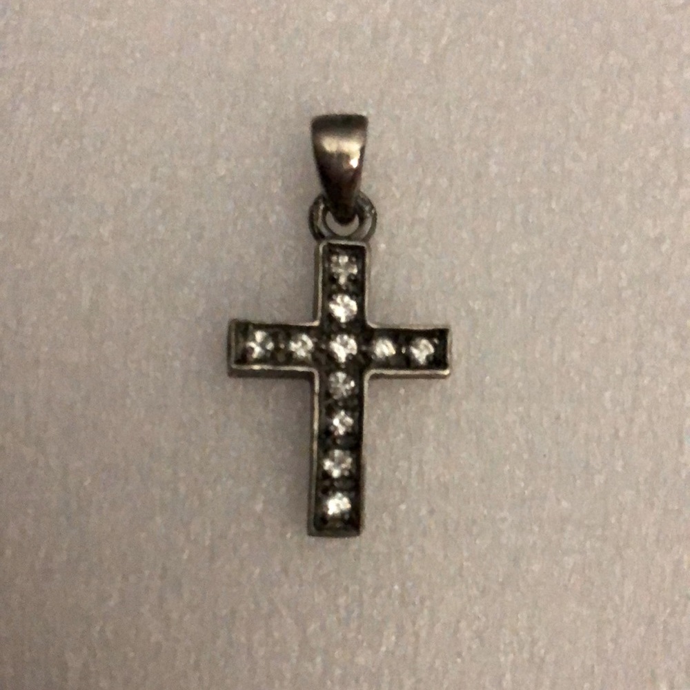 This is a Silver Cross with diamonds,. pendants necklace.